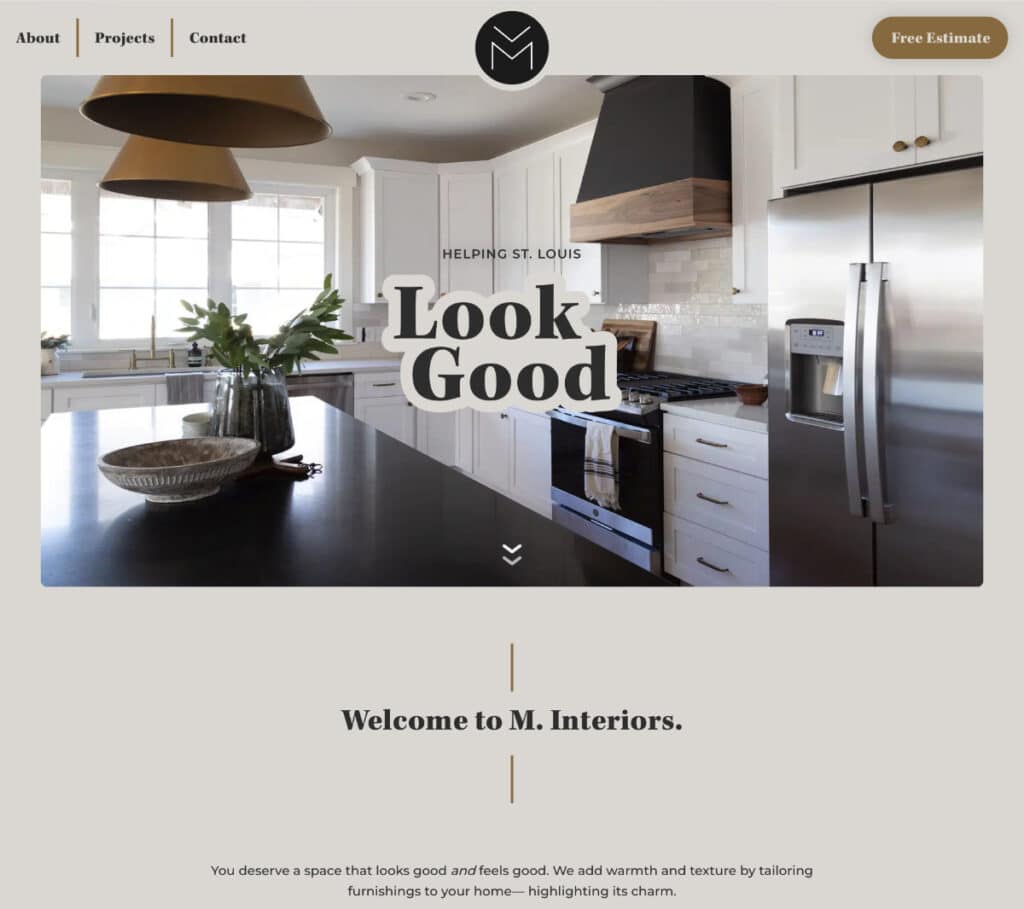 Website homepage for M. Interiors showing a modern kitchen with white cabinets, stainless steel appliances, and a dark island countertop. Text overlay reads ‘Helping St. Louis Look Good.’